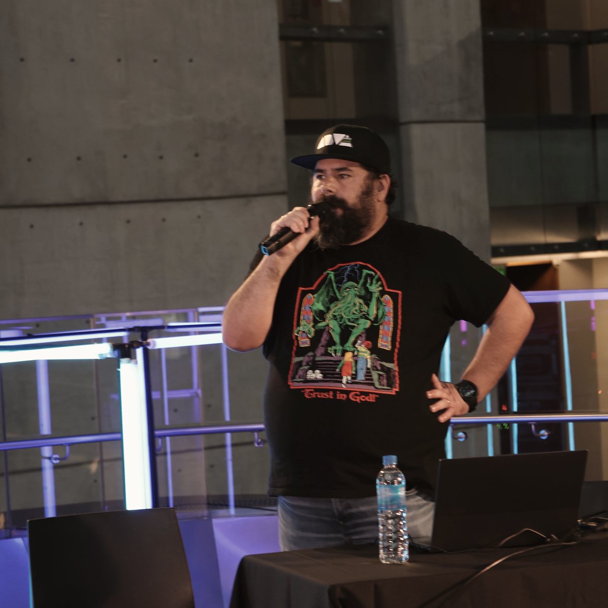 Lucas Wall on stage, speaking into a microphone.